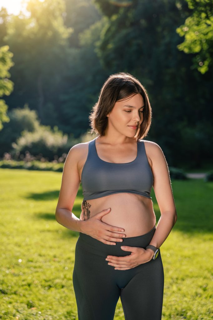 Pregnant woman holding her belly (model)